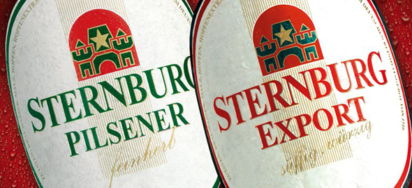 Two beer labels from Sternburg beer bottles, one with green lettering and one with red lettering.